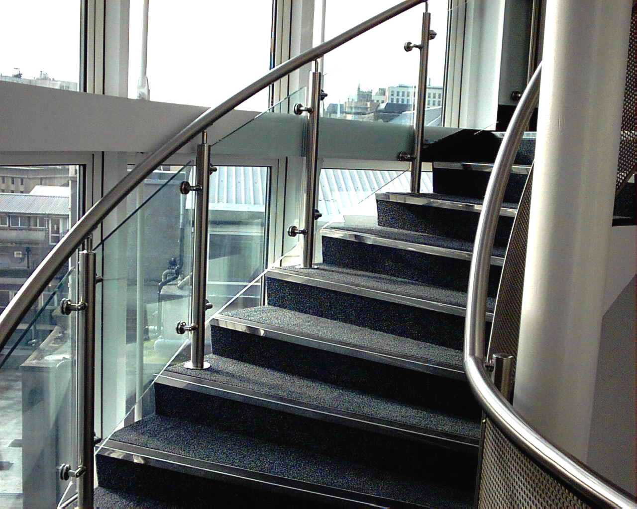 sweeping stainless steel handrail on staircase