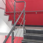 warm to touch handrail on staircase with red wall