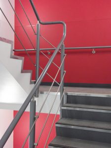 warm to touch handrail on staircase with red wall