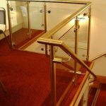 Brass handrail over staircase