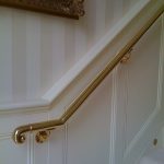 Brass handrail on residential staircase