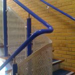 Blue DDA handrail with perforated infill