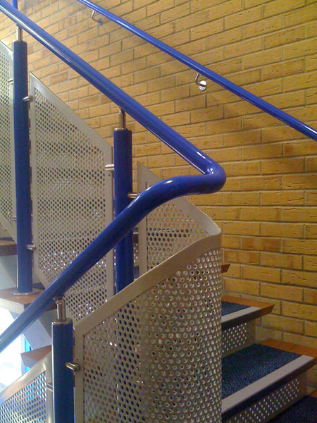 Blue DDA handrail with perforated infill